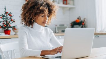 The lead image shows a woman working on a laptop.