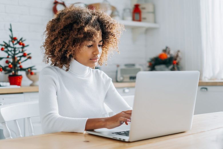 The lead image shows a woman working on a laptop.