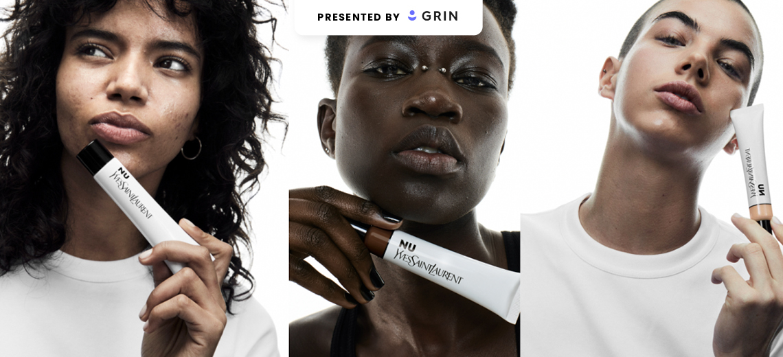 a featured image for a glossy pop story that is sponsored by Grin. The image shows three people holding Yves Saint Laurent beauty products.