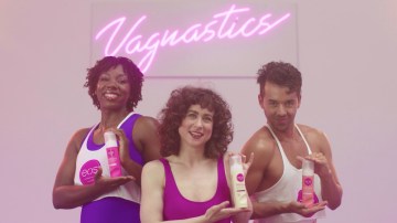 The header image shows three people holding up Eos products with a lit-up neon sign behind them that reads "Vagnastics."