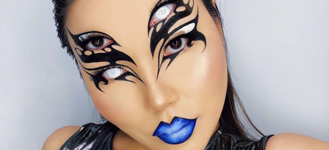 Photograph of woman with intricate face makeup.