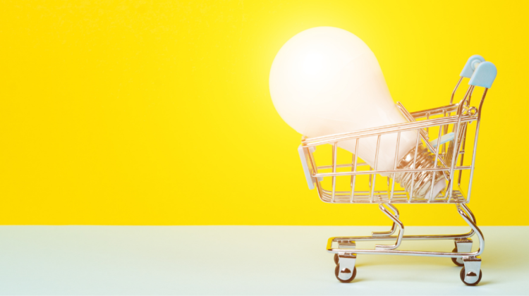 picture of a shopping cart with a bright, oversized lightbulb shining inside.