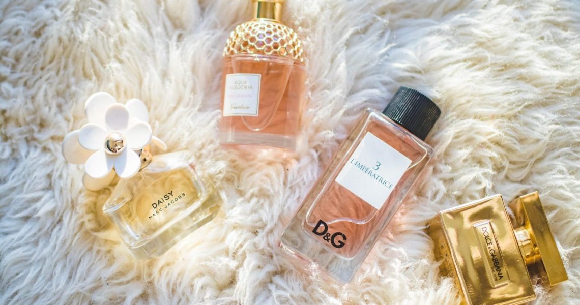 Photograph of perfume bottles on a furry background.