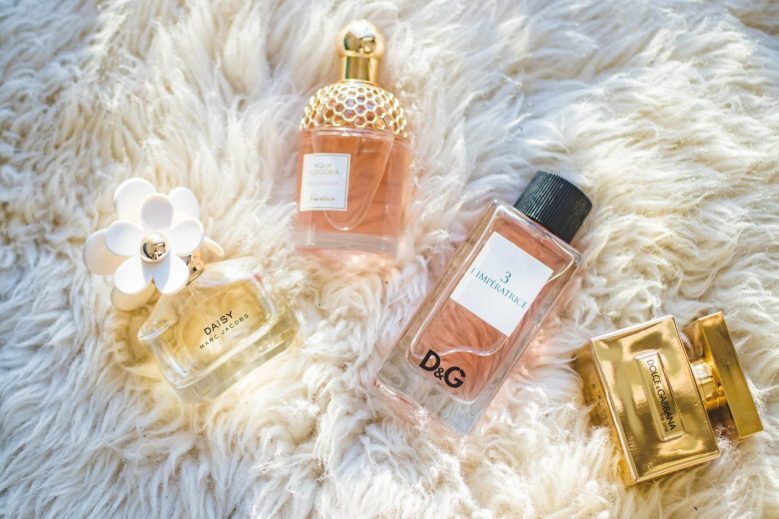Photograph of perfume bottles on a furry background.