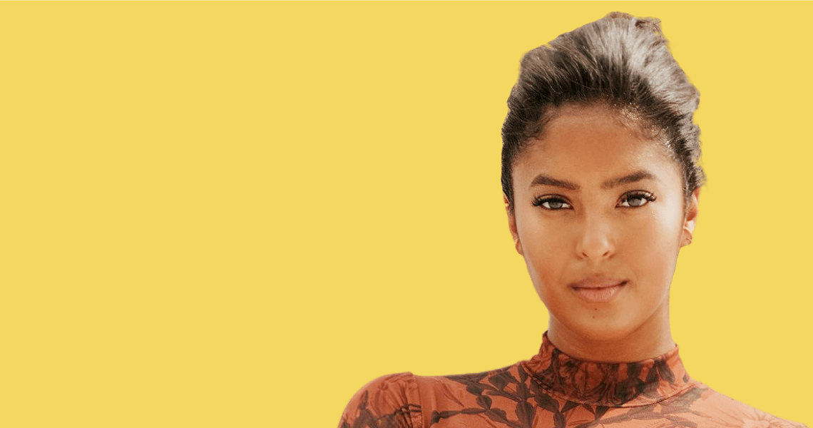 Natalia Bryant in front of yellow background