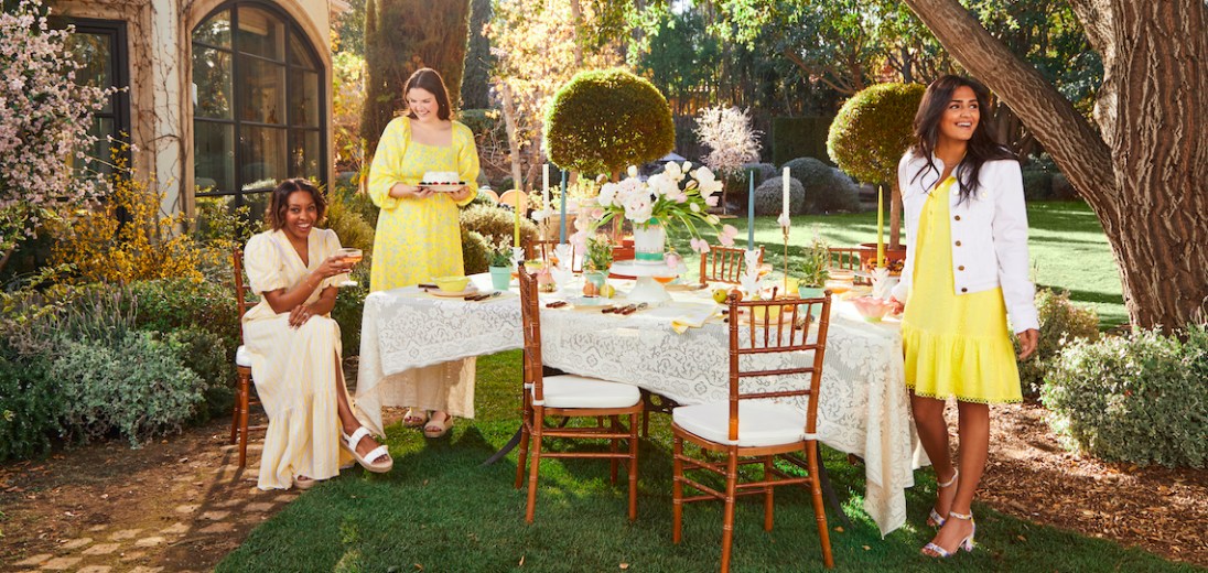 Draper James items set outside in a yellow and white picnic